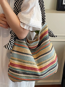 Colorful striped woven straw tote bag with large bow handle for summer beach vacations