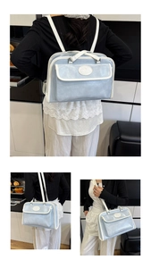 Detail showing the light blue metallic faux leather texture and white piping of the tote