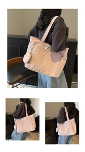 Detail view of large pink canvas tote bag with side coin purse and waswac rules woven label