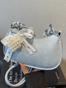 Blue pleated leather dumpling bag with pearl heart charm and lace bow decoration