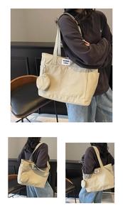Detail of a beige canvas tote bag with a matching round coin purse and brand label