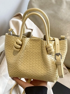 Fashionable pale yellow woven bucket bag with knot handle and adjustable strap
