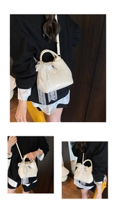 Detail of cream bucket bag featuring a white lace bow and elegant pearl string decoration