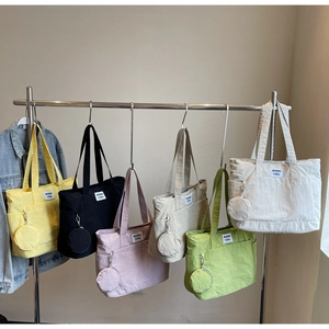 Detailed macro view of six colorful nylon tote bags with matching round mini coin purses