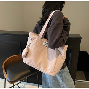 Detail view of pink large capacity tote bag with side pocket and small round coin purse