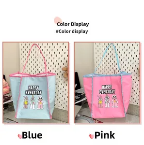 Detail view of large capacity cartoon tote bags in contrast blue and pink colors