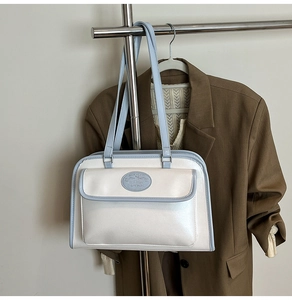 Detail view of Moon Shark tote bag showing glossy pearl white and light blue texture