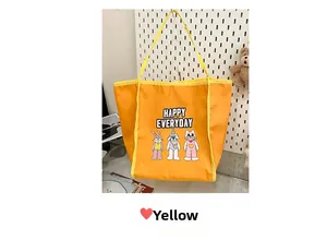 Detail of yellow canvas tote bag with cute animal prints and HAPPY EVERYDAY text