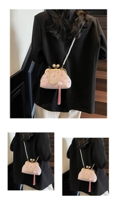Detail of vintage Chinese embroidery bag with pearl handles and pink silk tassel