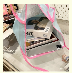 Spacious tote bag interior showing capacity for a tablet, books, and daily essentials