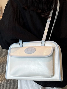 Minimalist pearl white underarm tote bag with light blue trim and Moon Shark logo