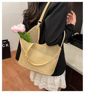 Detail of hollow woven tote bag with beige mesh texture and leather strap attachment
