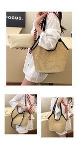 Detail of handwoven straw tote with black leather trim and removable canvas inner pouch