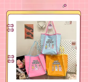 Detailed view of canvas tote bags with cartoon embroidery and Happy Everyday text