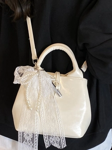 Chic cream white bucket bag with large pearl lace bow and top handle shoulder strap