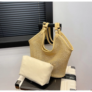 Detail of yellow hollow woven tote bag with a removable beige canvas inner pouch