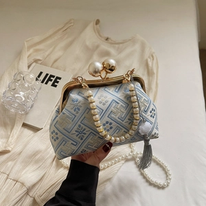 Detail of vintage Chinese embroidery bag with pearl handle and grey silk tassel accents