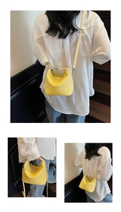 Detail of yellow lychee pattern bucket bag with adjustable strap and embossed logo
