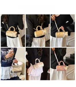 Detail shots of the stylish barrel handbag with pearl bow charm in multiple carrying styles