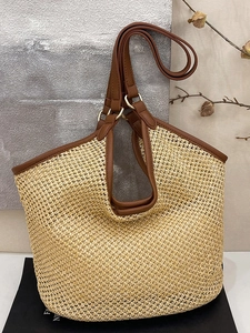 Large woven straw tote bag with brown leather straps and metal rings for summer beach vacations