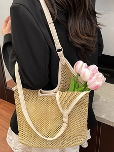 Large summer woven straw tote bag with cream leather straps for beach holidays