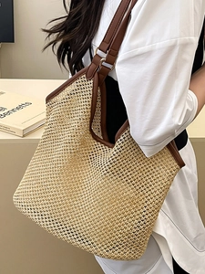 Minimalist beige woven straw tote bag with brown leather straps for beach vacation