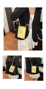 Macro detail of yellow quilted chain bag with rhinestone star and leather woven strap