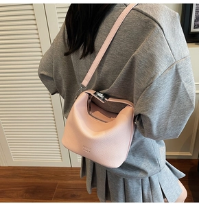 Pink lychee grain leather bucket bag with silver twist lock and crossbody strap