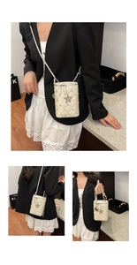 Detail of cream white quilted bucket bag with silver studs and crystal star decoration