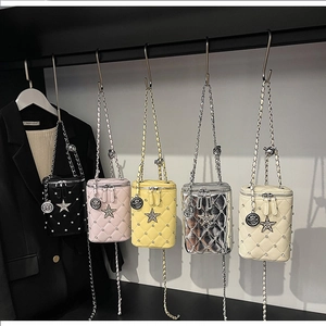 Detail view of colorful quilted chain bags hanging on a display with star rhinestone