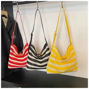 Three woven mesh tote bags with stripes and horn button closure detail in various colors