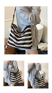 Macro detail of woven striped tote bag showing mesh texture and wooden button closure