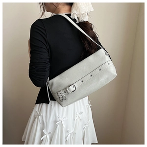 Detail of light gray shoulder bag with silver ring buckle and subtle pleated texture