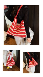 Detail of red and white striped woven tote bag featuring a leather trim and wooden toggle closure