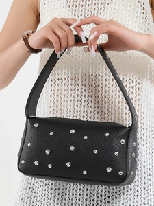 Vintage style black leather underarm bag with silver metallic studs and textured finish