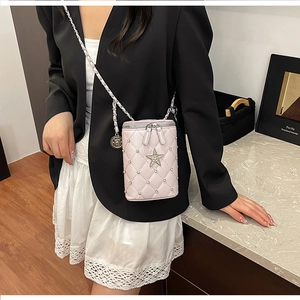 Detail of pink quilted crossbody phone bag with star logo and leather chain strap