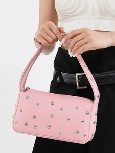 Pink leather shoulder bag with metallic studs and vintage aesthetic for women