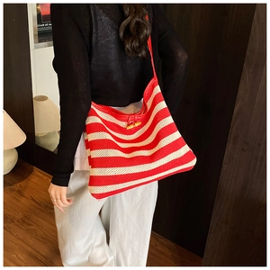 Detail of red and cream striped woven tote bag with a unique bamboo clasp closure