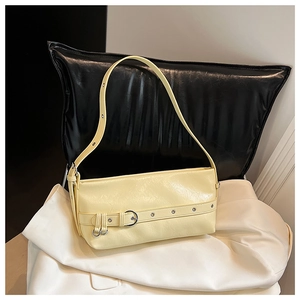 Detailed close-up of light yellow PU leather handbag with silver buckle and litchi texture