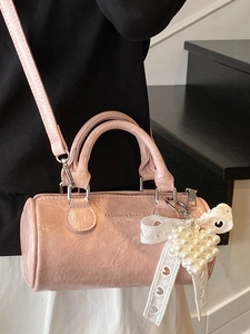 Pink cylinder boston bag in pleated patent leather with pearl heart charm