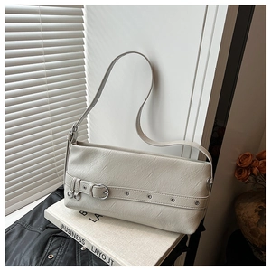 Detail of off-white leather underarm bag with vintage silver buckle and pleated texture