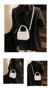 Détail du mini sac blanc avec poignée sphérique porté par un mannequin chic