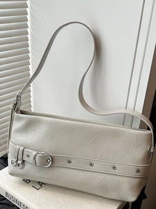 Minimalist cream shoulder bag with metallic buckle detail for a retro fashion look
