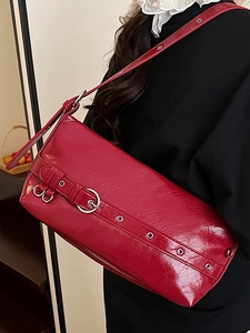 Minimalist red glossy shoulder bag with metallic buckle and leather texture for women