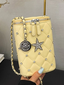 Quilted diamond pattern crossbody bag with rhinestone accents and chain strap in yellow
