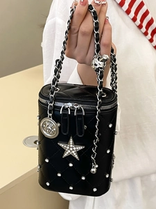 Chic black quilted cylinder vanity bag with rhinestone stars and chain strap