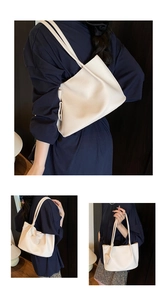 Detail view of cream white tote bag in lychee pattern leather with side knot accents