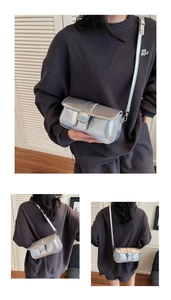 Detail view of silver matte underarm bag with flap design and adjustable shoulder strap
