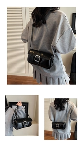 Detail of black glossy leather shoulder bag with sleek silver square buckle and flap closure