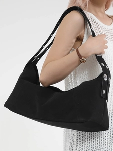 Women's black canvas shoulder bag with metallic eyelet straps for summer 2025 fashion